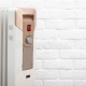 modern electric oil heating radiator against white brick wall concept turning apartments cold season autumn