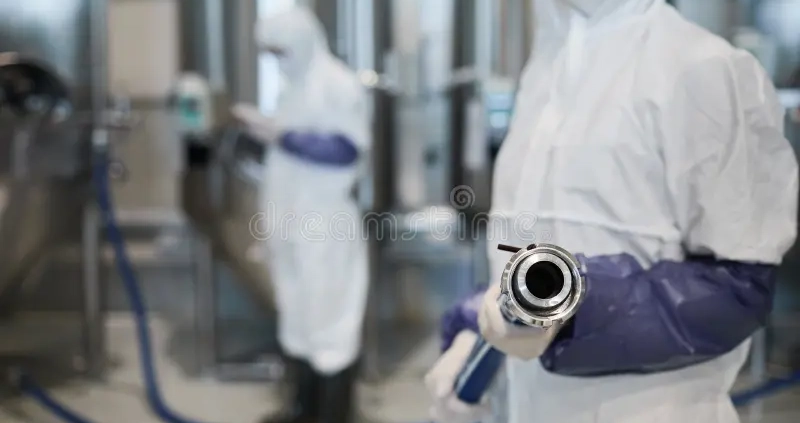 worker pointing hose camera chemical plant close up unrecognizable wearing protective suit holding hoae workshop copy