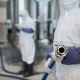 worker pointing hose camera chemical plant close up unrecognizable wearing protective suit holding hoae workshop copy